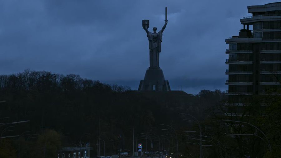Cars drive on a dark street with a Monument Motherland on the background during a blackout after a Russian missile attack on Ukrainian power infrastructure in Kyiv, Ukraine, November 03, 2022 (Maxym Marusenko/NurPhoto via Getty Images)