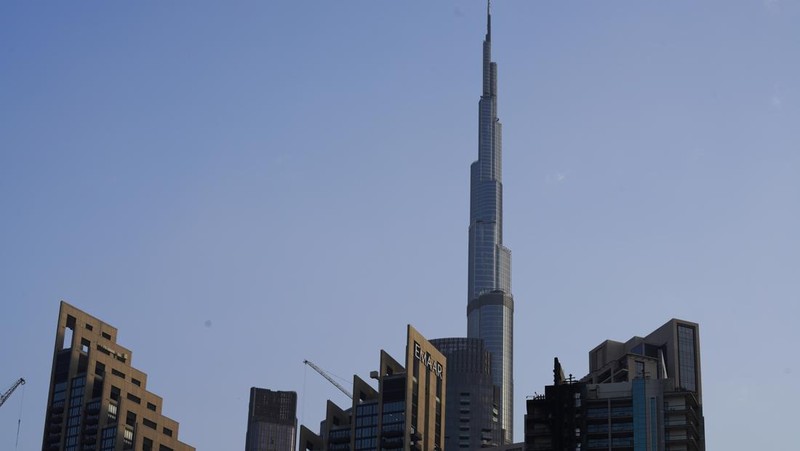 The high-rise 8 Boulevard Walk, bottom right, shows fire damage with the Burj Khalifa, the world's tallest building, seen behind it in Dubai, United Arab Emirates, Monday, Nov. 7, 2022. A fire broke out early Monday morning at a 35-story high-rise building in Dubai near the Burj Khalifa, the world's tallest building. (AP Photo/Jon Gambrell)