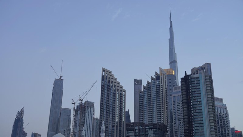 The high-rise 8 Boulevard Walk, bottom right, shows fire damage with the Burj Khalifa, the world's tallest building, seen behind it in Dubai, United Arab Emirates, Monday, Nov. 7, 2022. A fire broke out early Monday morning at a 35-story high-rise building in Dubai near the Burj Khalifa, the world's tallest building. (AP Photo/Jon Gambrell)