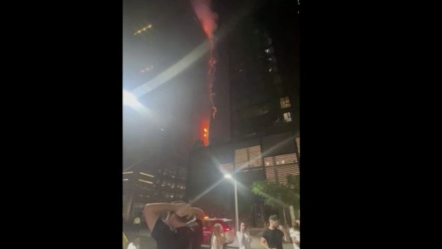 Kebakaran terjadi di gedung dekat dengan Burj Khalifa, gedung tertinggi di dunia, terlihat di belakangnya di Dubai, Uni Emirat Arab, Senin, 7 November 2022. (Tangkapan Layar Video/ Romanna Dada via Reuters)