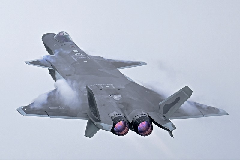 Pengunjung berkumpul untuk mengambil gambar jet tempur siluman J-20 selama Pameran Penerbangan dan Antariksa Internasional China ke-14 di Zhuhai di provinsi Guangdong, China selatan, Selasa (8/11/202). China menampilkan generasi jet tempur terbarunya. (Lu Hanxin/Xinhua via AP)