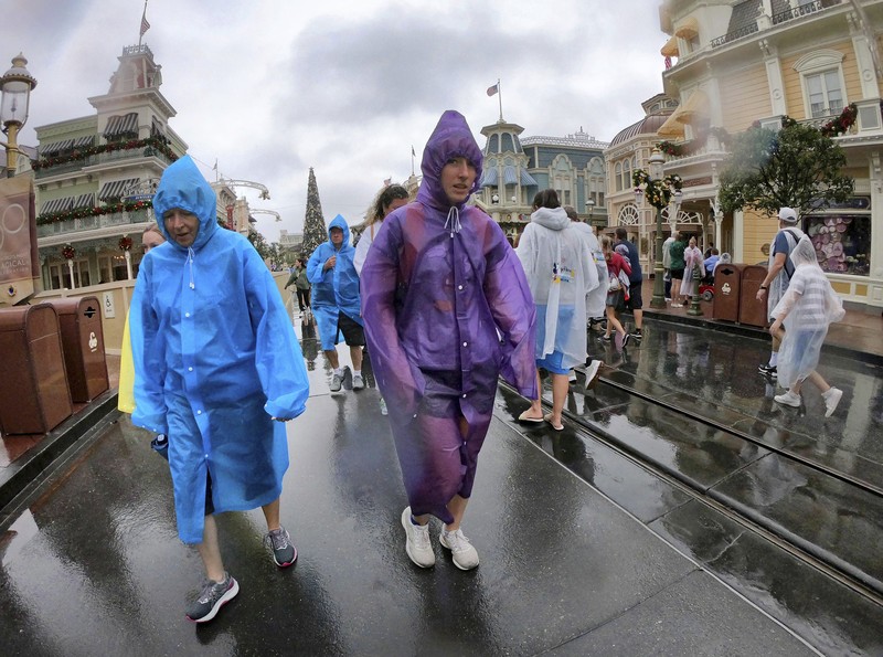 4 taman Disney di Florida Tengah ditutup Rabu pagi karena badai Nicole yang menerjang pantai di Florida, AS, pada (9/11/2022). Guests brave the weather in the Magic Kingdom at Walt Disney World in Lake Buena Vista, Fla., Wednesday, Nov. 9, 2022, as conditions deteriorate with the approach of Hurricane Nicole. All 4 Disney parks in Central Florida closed early Wednesday because of the impending storm. (Joe Burbank/Orlando Sentinel via AP)