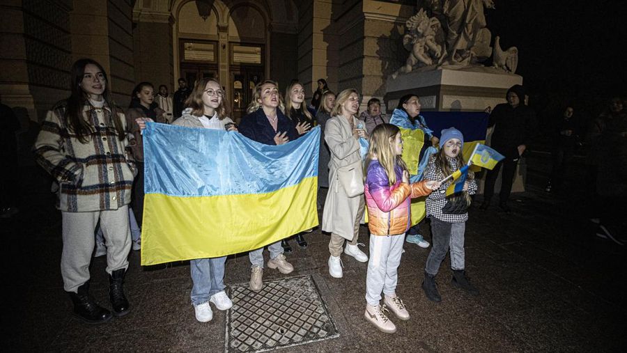 ODESSA, UKRAINE - NOVEMBER 11: Citizens who lived in Kherson before and had to leave the city due to the war, gather in front of the Odessa National Academic Theater of Opera and Ballet, in Odessa to celebrate the retreat of Russian forces from Kherson, on November 11, 2022 in Odessa, Ukraine. The Ukrainian military on Friday entered the southern city of Kherson after Russian retreat from the region. (Photo by Metin Aktas/Anadolu Agency via Getty Images)