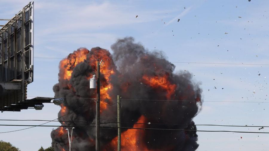 In this photo provided by Nathaniel Ross Photography, a historic military plane crashes after colliding with another plane during an airshow at Dallas Executive Airport in Dallas on Saturday, Nov. 12, 2022. (Nathaniel Ross Photography via AP)
