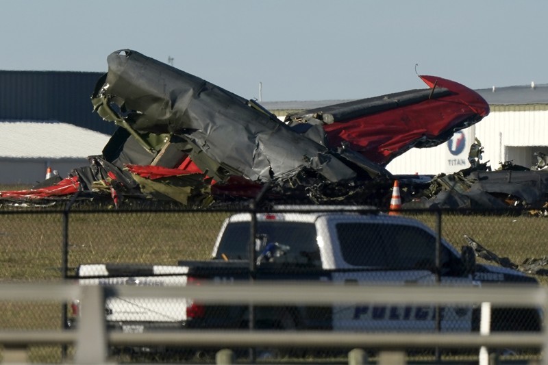 In this photo provided by Nathaniel Ross Photography, a historic military plane crashes after colliding with another plane during an airshow at Dallas Executive Airport in Dallas on Saturday, Nov. 12, 2022. (Nathaniel Ross Photography via AP)