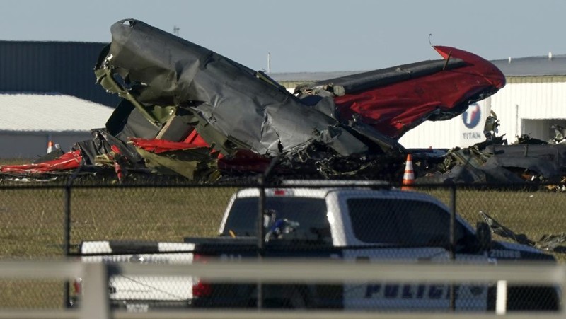 In this photo provided by Nathaniel Ross Photography, a historic military plane crashes after colliding with another plane during an airshow at Dallas Executive Airport in Dallas on Saturday, Nov. 12, 2022. (Nathaniel Ross Photography via AP)