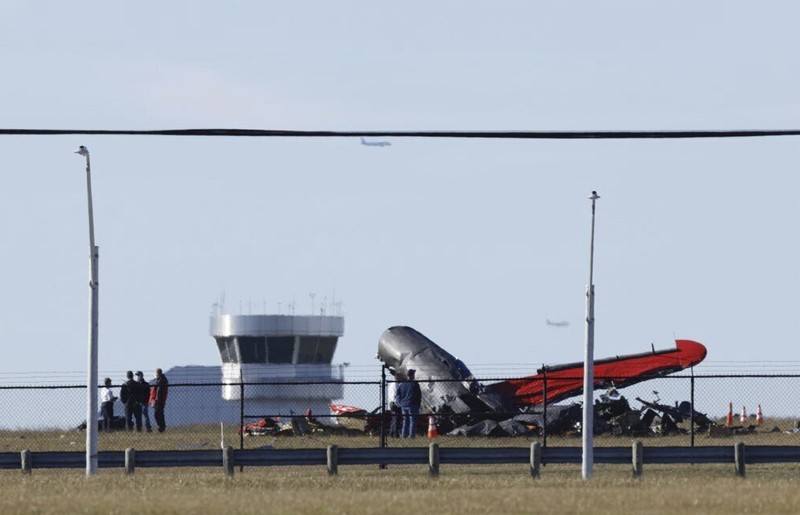 APTOPIX Dallas Air Show Crash In this photo provided by Nathaniel Ross Photography, a historic military plane crashes after colliding with another plane during an airshow at Dallas Executive Airport in Dallas on Saturday, Nov. 12, 2022. (Nathaniel Ross Photography via AP)