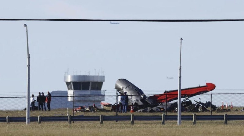 In this photo provided by Nathaniel Ross Photography, a historic military plane crashes after colliding with another plane during an airshow at Dallas Executive Airport in Dallas on Saturday, Nov. 12, 2022. (Nathaniel Ross Photography via AP)