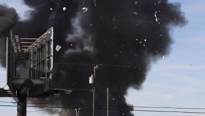 In this photo provided by Nathaniel Ross Photography, a historic military plane crashes after colliding with another plane during an airshow at Dallas Executive Airport in Dallas on Saturday, Nov. 12, 2022. (Nathaniel Ross Photography via AP)