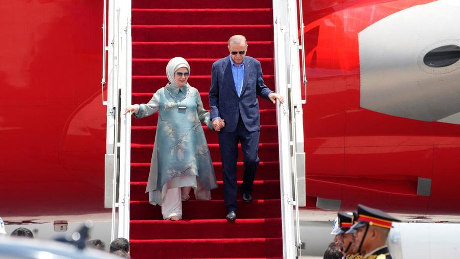 Turkish President Recep Tayyip Erdogan, right, and his wife Emine disembark from their plane upon arrival at Ngurah Rai International Airport ahead of the G20 Summit in Bali, Indonesia, Monday, Nov. 14, 2022. Firdia Lisnawati/Pool via REUTERS