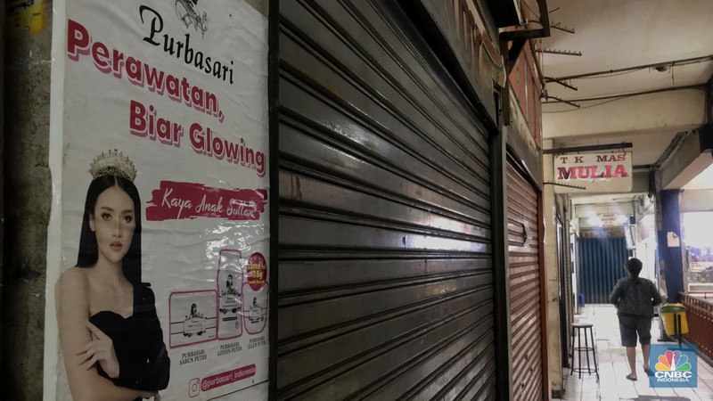 Pengunjnung melintas di depan kios yang tutul di pasar Mampang, Senin (14/112/2022). Sepinya pengunjung di Pasar Mampang membuat para pedagang  memilih menjual atau menyewakan kiosnya. (CNBC Indonesia/Andrean Kristianto)