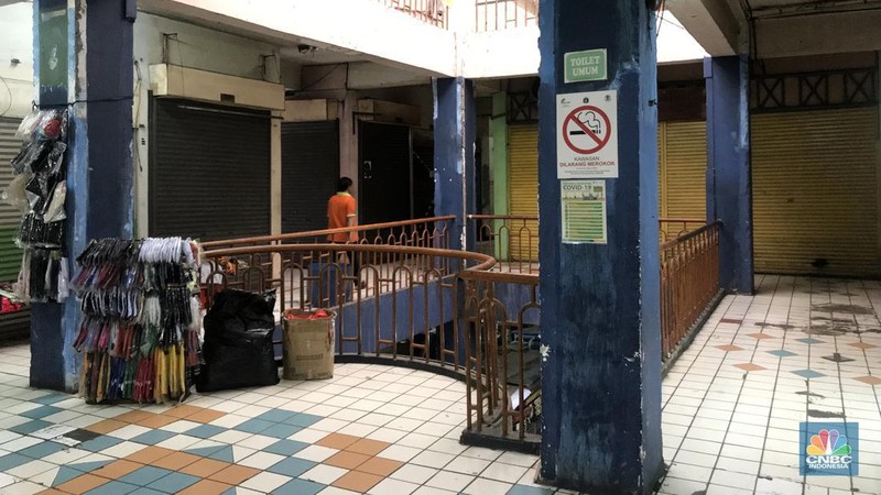 Pengunjnung melintas di depan kios yang tutul di pasar Mampang, Senin (14/112/2022). Sepinya pengunjung di Pasar Mampang membuat para pedagang  memilih menjual atau menyewakan kiosnya. (CNBC Indonesia/Andrean Kristianto)