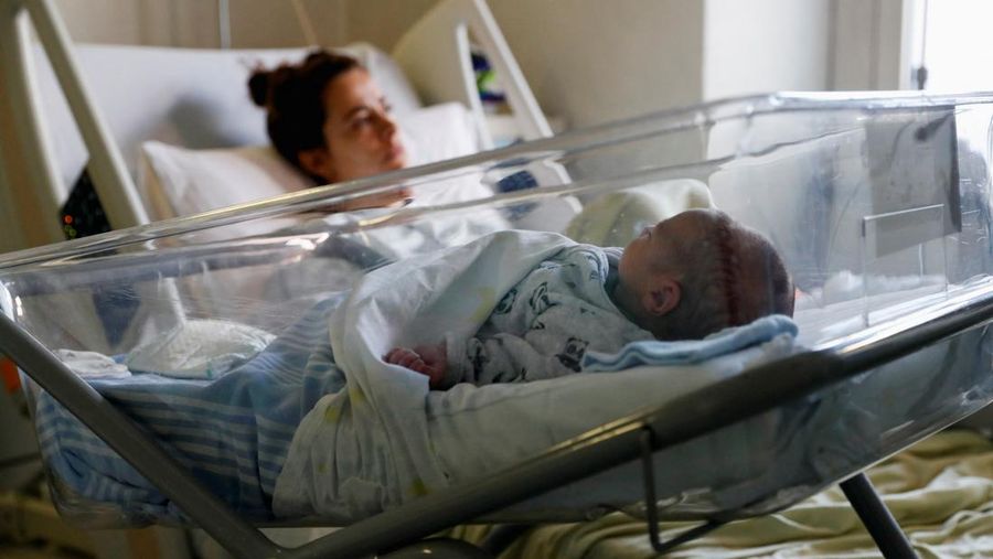 Newborn baby Leonardo rests on his mum's Viviana Valente arms, inside a room of the Santo Spirito Hospital, as the UN forecasts the world will reach 8 billion people around November 15, 2022, in Rome, Italy, November 14, 2022. REUTERS/Remo Casilli     TPX IMAGES OF THE DAY