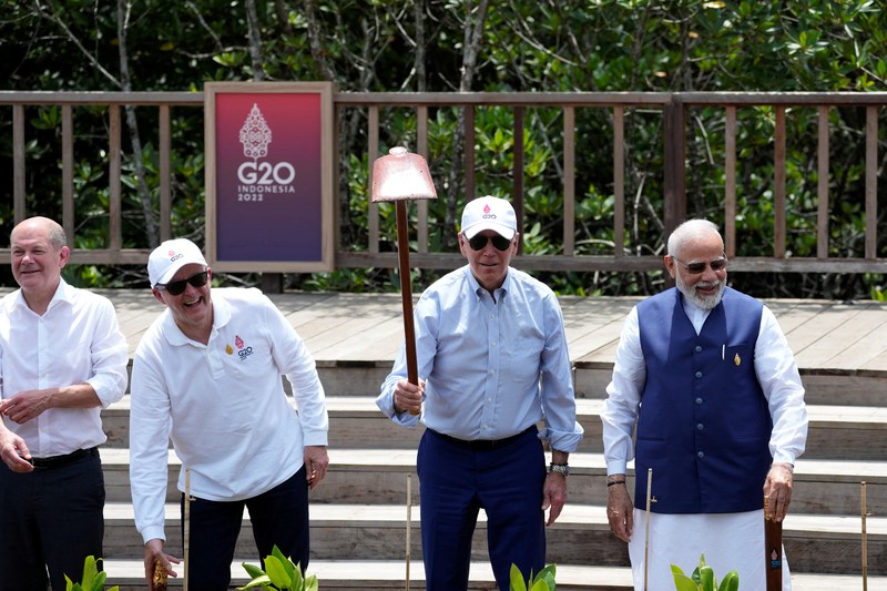 Biden G20 Leaders raise their garden hoes for a group photo during a tree planting event at the Taman Hutan Raya Ngurah Rai Mangrove Forest, on the sidelines of the G20 summit meeting, Wednesday, Nov. 16, 2022, in Denpasar, Bali, Indonesia. (AP Photo/Alex Brandon, Pool)