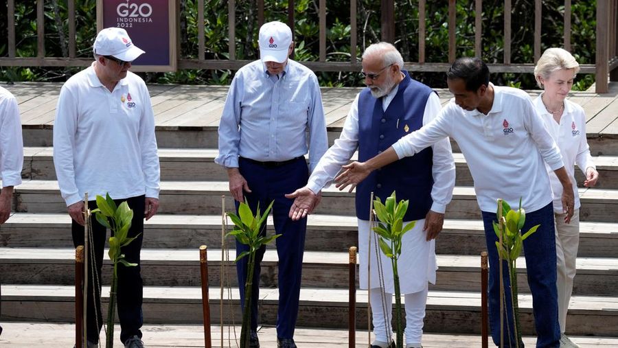 Leaders raise their garden hoes for a group photo during a tree planting event at the Taman Hutan Raya Ngurah Rai Mangrove Forest, on the sidelines of the G20 summit meeting, Wednesday, Nov. 16, 2022, in Denpasar, Bali, Indonesia. (AP Photo/Alex Brandon, Pool)