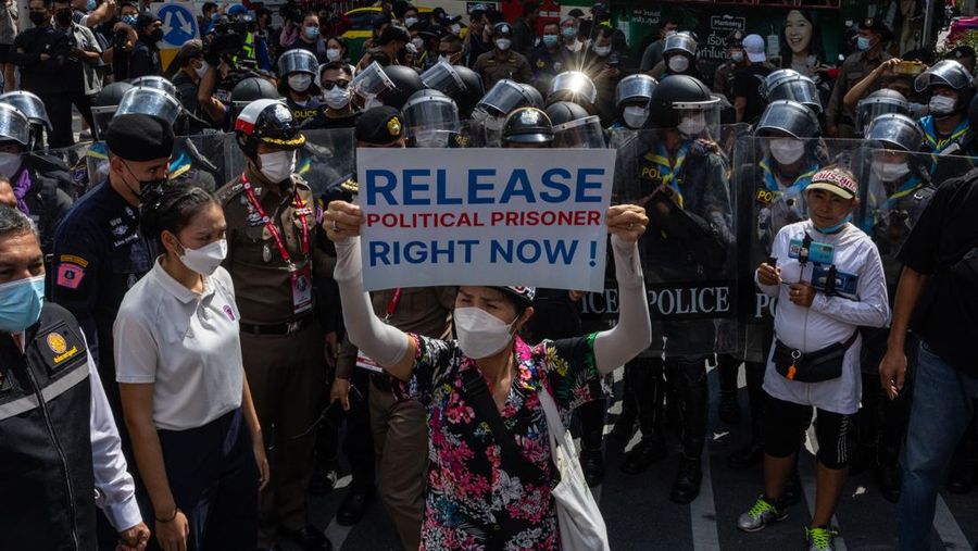 Demonstrators push a vehicle as police officers with shields stand guard near them during a protest against the Asia-Pacific Economic Cooperation (APEC) Summit 2022, near the Democracy Monument in Bangkok, Thailand November 18, 2022. REUTERS/Chalinee Thirasupa