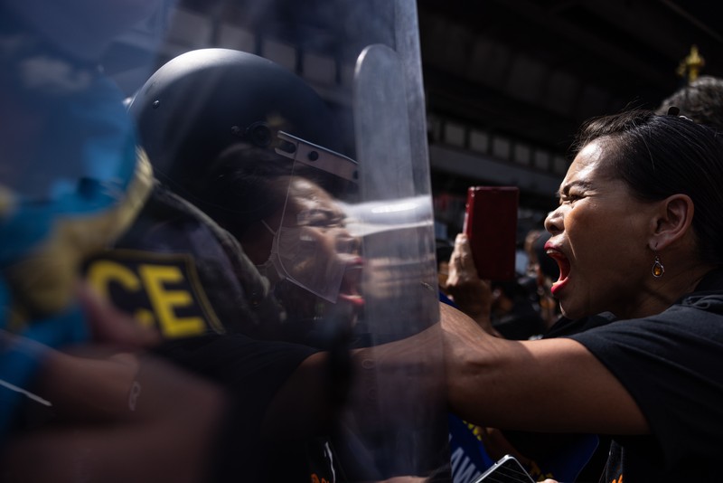 BANGKOK, THAILAND - NOVEMBER 17: A protester carries a Winnie the Pooh teddy bear representing Xi Jinping next to riot police during a demonstration nearby the site of the Asia-Pacific Economic Cooperation (APEC) summit on November 17, 2022 in Bangkok, Thailand. Thailand is hosting the APEC meetings this year, which will culminate in the leaders' meetings which will run from Nov. 17 to 19. (Photo by Louise Delmotte/Getty Images)