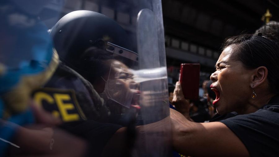 BANGKOK, THAILAND - NOVEMBER 17: A protester carries a Winnie the Pooh teddy bear representing Xi Jinping next to riot police during a demonstration nearby the site of the Asia-Pacific Economic Cooperation (APEC) summit on November 17, 2022 in Bangkok, Thailand. Thailand is hosting the APEC meetings this year, which will culminate in the leaders' meetings which will run from Nov. 17 to 19. (Photo by Louise Delmotte/Getty Images)