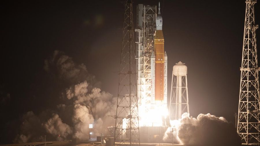 People at Veterans Memorial park watch as the Artemis I unmanned lunar rocket lifts off from launch pad 39B at NASA's Kennedy Space Center, in Titusville, Florida, on November 16, 2022. - NASA's Artemis 1 mission is a 25-and-a-half day voyage beyond the far side of the Moon and back. The meticulously choreographed uncrewed flight should yield spectacular images as well as valuable scientific data. (Photo by Marco BELLO / AFP) (Photo by MARCO BELLO/AFP via Getty Images)
