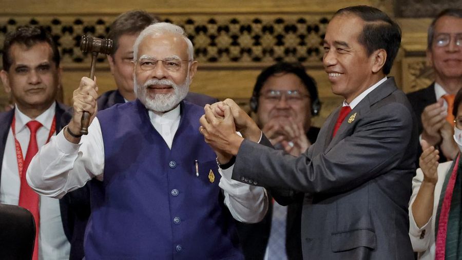 India's Prime Minister Narendra Modi, left, holds the gavel with Indonesia's President Joko Widodo during handover ceremony at the G20 Leaders' Summit, in Nusa Dua, Bali, Indonesia, Wednesday Nov. 16, 2022. (Willy Kurniawan/Pool Photo via AP)