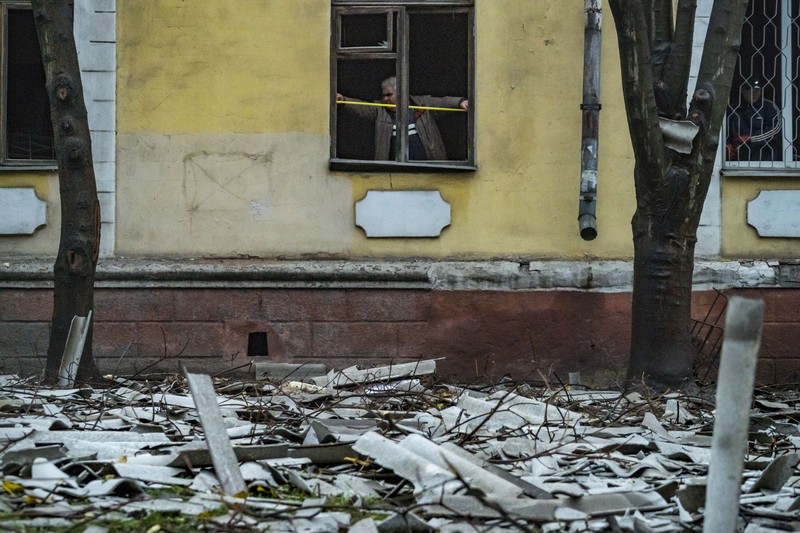 A man takes measures of his destroyed window by the shock wave of the explosion of a russian missile over Dnipro city, Ukraine. (Photo by Celestino Arce/NurPhoto via Getty Images)