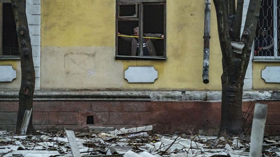 A man takes measures of his destroyed window by the shock wave of the explosion of a russian missile over Dnipro city, Ukraine. (Photo by Celestino Arce/NurPhoto via Getty Images)