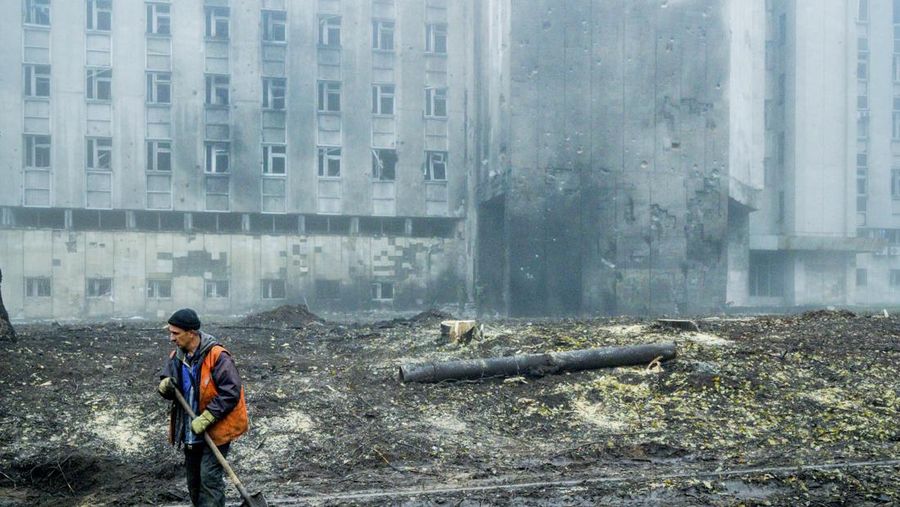 A worker cleans the debrish in the streets of Dnipro  after a russian missile impacted in the city. (Photo by Celestino Arce/NurPhoto via Getty Images)