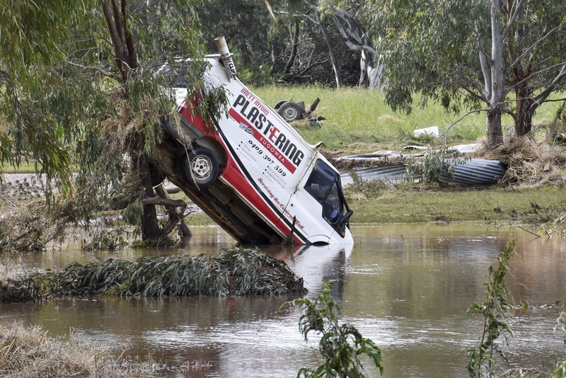 Australia Floods One of the many vehicles swept away during a flash flood, sits embedded in a tree in the town of Eugowra, Central West New South Wales, Tuesday, Nov. 15, 2022. A rare third consecutive La Niña weather pattern, which is associated with above-average rainfall in eastern Australia, has created a flooding emergency across large swathes of New South Wales that has lasted for two months.(Murray McCloskey/AAP Image via AP)