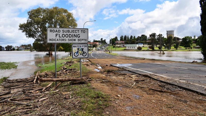 One of the many vehicles swept away during a flash flood, sits embedded in a tree in the town of Eugowra, Central West New South Wales, Tuesday, Nov. 15, 2022. A rare third consecutive La Niña weather pattern, which is associated with above-average rainfall in eastern Australia, has created a flooding emergency across large swathes of New South Wales that has lasted for two months.(Murray McCloskey/AAP Image via AP)