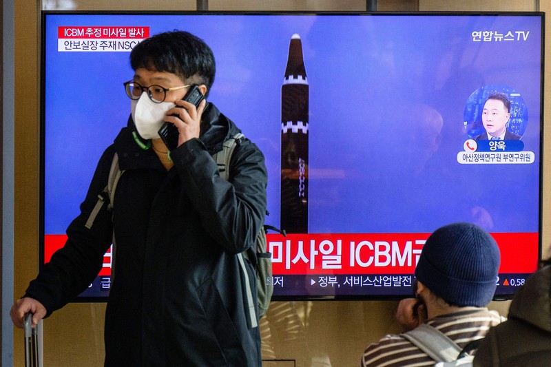 TOPSHOT - A man watches a television showing a news broadcast with file footage of a North Korean missile test, at a railway station in Seoul on November 18, 2022. - A suspected intercontinental ballistic missile launched by North Korea on Friday is believed to have fallen in Japan's exclusive economic waters, Japanese Prime Minister Fumio Kishida said. (Photo by Anthony WALLACE / AFP) (Photo by ANTHONY WALLACE/AFP via Getty Images)