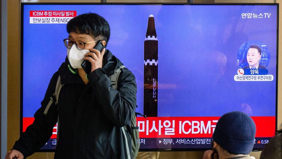 TOPSHOT - A man watches a television showing a news broadcast with file footage of a North Korean missile test, at a railway station in Seoul on November 18, 2022. - A suspected intercontinental ballistic missile launched by North Korea on Friday is believed to have fallen in Japan's exclusive economic waters, Japanese Prime Minister Fumio Kishida said. (Photo by Anthony WALLACE / AFP) (Photo by ANTHONY WALLACE/AFP via Getty Images)