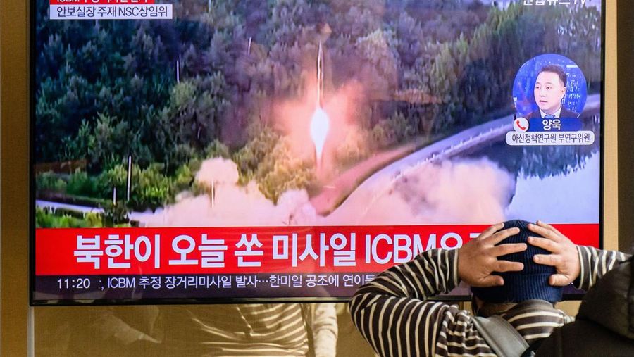 TOPSHOT - A man watches a television showing a news broadcast with file footage of a North Korean missile test, at a railway station in Seoul on November 18, 2022. - A suspected intercontinental ballistic missile launched by North Korea on Friday is believed to have fallen in Japan's exclusive economic waters, Japanese Prime Minister Fumio Kishida said. (Photo by Anthony WALLACE / AFP) (Photo by ANTHONY WALLACE/AFP via Getty Images)