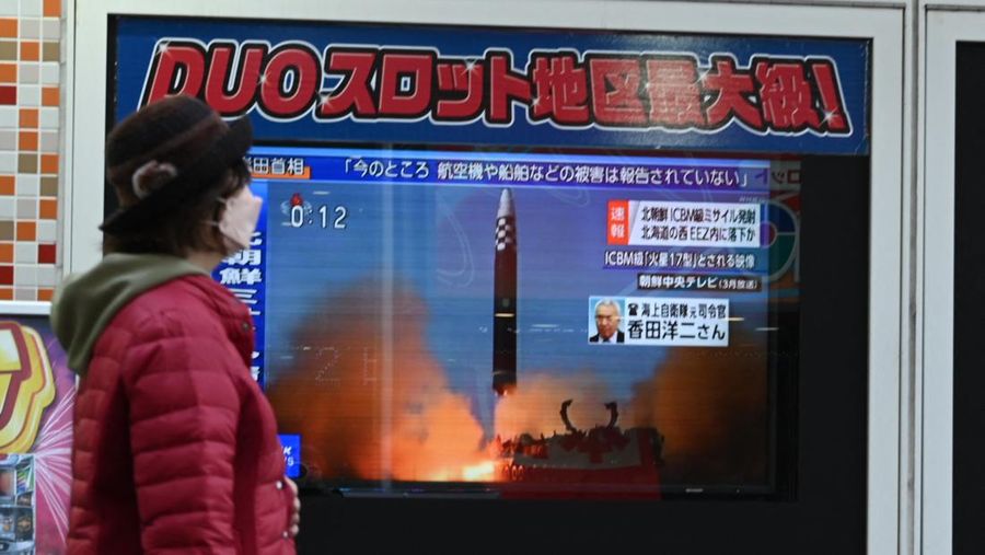 TOPSHOT - A man watches a television showing a news broadcast with file footage of a North Korean missile test, at a railway station in Seoul on November 18, 2022. - A suspected intercontinental ballistic missile launched by North Korea on Friday is believed to have fallen in Japan's exclusive economic waters, Japanese Prime Minister Fumio Kishida said. (Photo by Anthony WALLACE / AFP) (Photo by ANTHONY WALLACE/AFP via Getty Images)