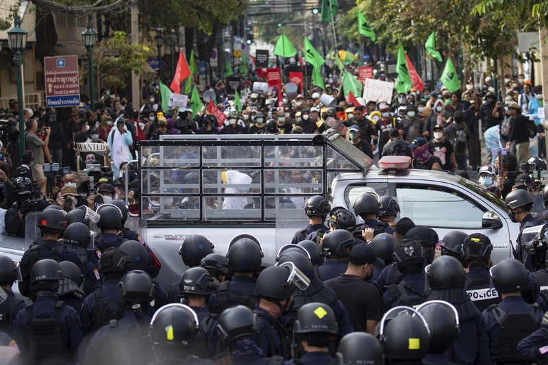 Para demonstran anti-pemerintah kembali bentrok dengan polisi anti huru-hara dalam rangka menolak aktivitas KTT APEC di Bangkok. Demonstrators push a vehicle as police officers with shields stand guard near them during a protest against the Asia-Pacific Economic Cooperation (APEC) Summit 2022, near the Democracy Monument in Bangkok, Thailand November 18, 2022. REUTERS/Chalinee Thirasupa