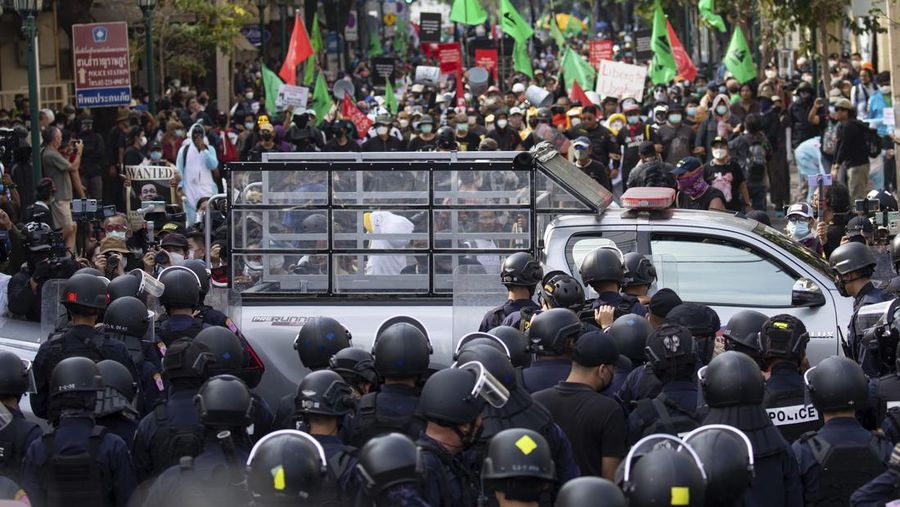 Demonstrators push a vehicle as police officers with shields stand guard near them during a protest against the Asia-Pacific Economic Cooperation (APEC) Summit 2022, near the Democracy Monument in Bangkok, Thailand November 18, 2022. REUTERS/Chalinee Thirasupa