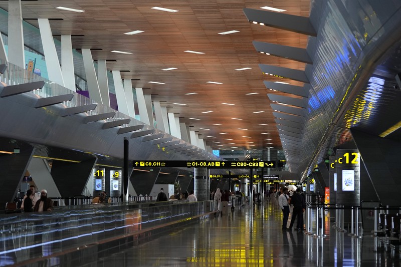 Passengers walk at Hamad International Airport in Doha, Qatar, Thursday, Nov. 10, 2022.   (AP Photo/Hassan Ammar)