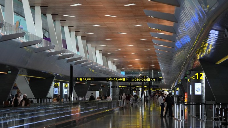 Passengers walk at Hamad International Airport in Doha, Qatar, Thursday, Nov. 10, 2022.   (AP Photo/Hassan Ammar)