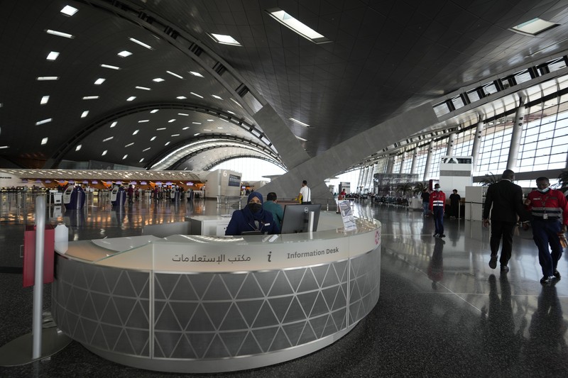 Passengers walk at Hamad International Airport in Doha, Qatar, Thursday, Nov. 10, 2022.   (AP Photo/Hassan Ammar)
