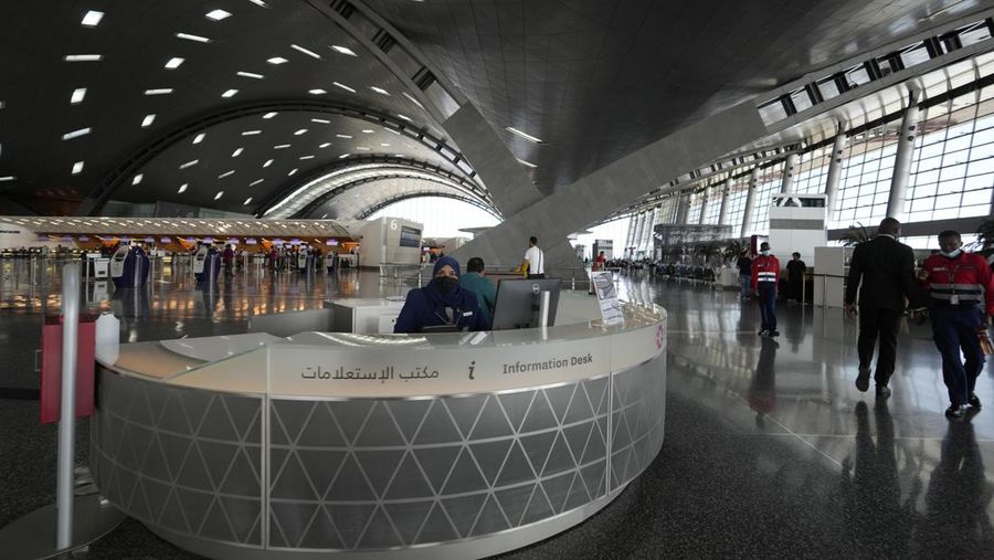 Passengers walk at Hamad International Airport in Doha, Qatar, Thursday, Nov. 10, 2022.   (AP Photo/Hassan Ammar)