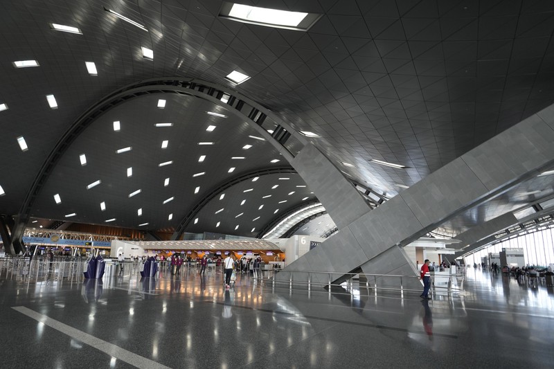Passengers walk at Hamad International Airport in Doha, Qatar, Thursday, Nov. 10, 2022.   (AP Photo/Hassan Ammar)