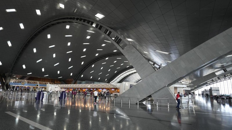 Passengers walk at Hamad International Airport in Doha, Qatar, Thursday, Nov. 10, 2022.   (AP Photo/Hassan Ammar)