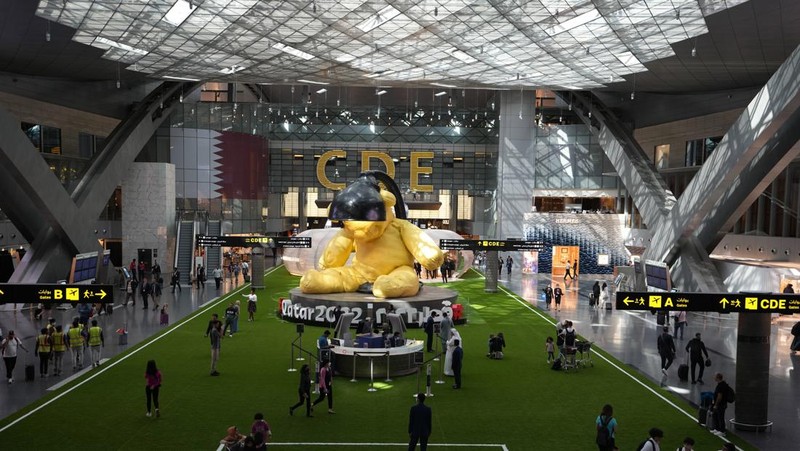 Passengers walk at Hamad International Airport in Doha, Qatar, Thursday, Nov. 10, 2022.   (AP Photo/Hassan Ammar)