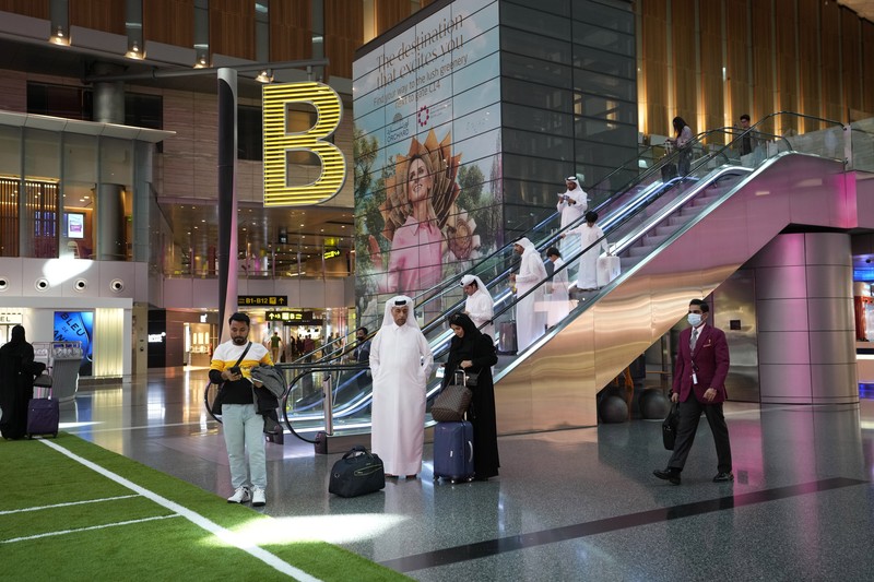 Passengers walk at Hamad International Airport in Doha, Qatar, Thursday, Nov. 10, 2022.   (AP Photo/Hassan Ammar)