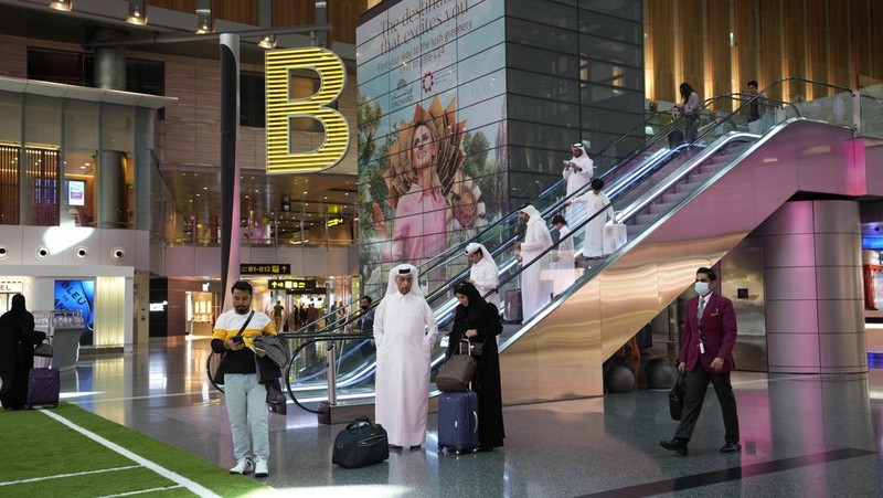 Passengers walk at Hamad International Airport in Doha, Qatar, Thursday, Nov. 10, 2022.   (AP Photo/Hassan Ammar)