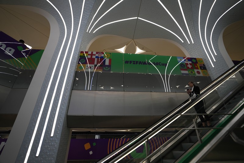 Passengers walk at Hamad International Airport in Doha, Qatar, Thursday, Nov. 10, 2022.   (AP Photo/Hassan Ammar)