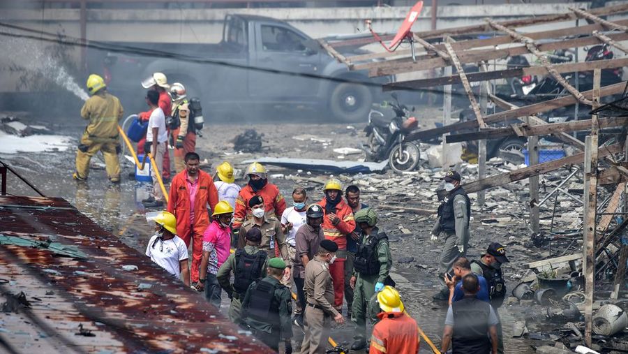 Police officials stand near a partly damaged car, after a car bomb exploded outside a police accommodation in Narathiwat town, southern Thailand, on November 22, 2022. - One person died and more than two dozen were injured in the attack, the provincial governor said. (Photo by MADAREE THOLALA / AFP) (Photo by MADAREE THOLALA/AFP via Getty Images)