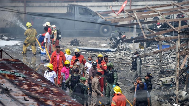 Police officials stand near a partly damaged car, after a car bomb exploded outside a police accommodation in Narathiwat town, southern Thailand, on November 22, 2022. - One person died and more than two dozen were injured in the attack, the provincial governor said. (Photo by MADAREE THOLALA / AFP) (Photo by MADAREE THOLALA/AFP via Getty Images)