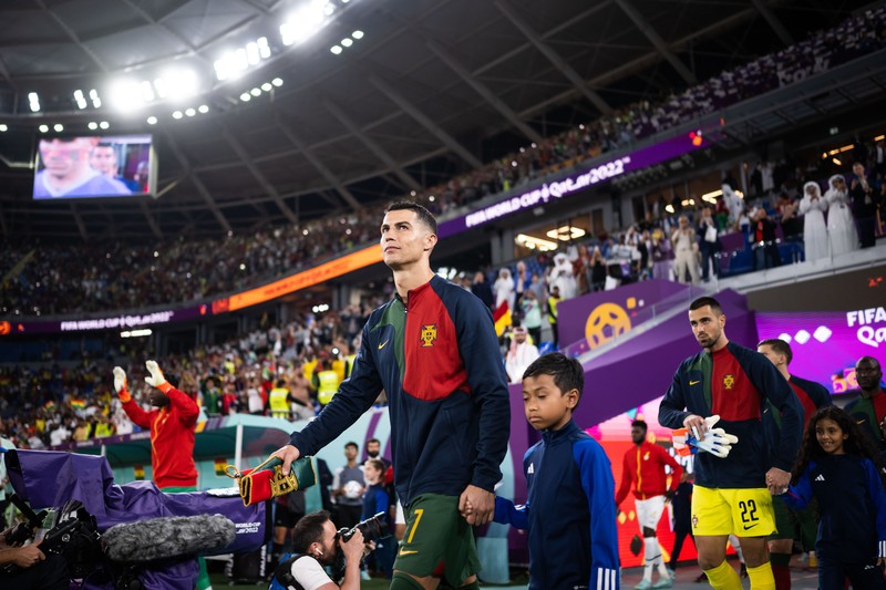 DOHA, QATAR - NOVEMBER 24: Cristiano Ronaldo of Portugal is seen in the tunnel with player mascots prior to the FIFA World Cup Qatar 2022 Group H match between Portugal and Ghana at Stadium 974 on November 24, 2022 in Doha, Qatar. (Photo by Sarah Stier - FIFA/FIFA via Getty Images)