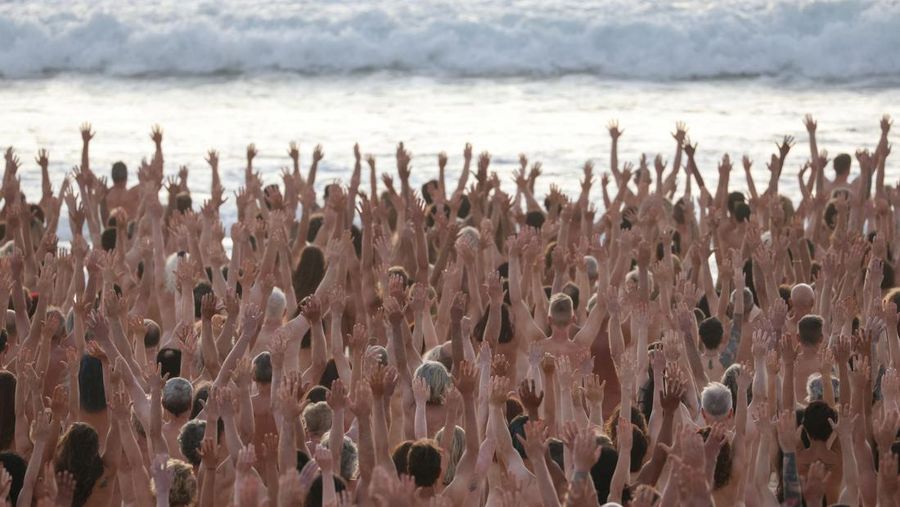 People stand naked as part of artist Spencer Tunick's art installation to raise awareness of skin cancer and encourage people to have their skin checked, at Bondi Beach in Sydney, Australia, November 26, 2022.  REUTERS/Loren Elliott  EDITORIAL USE ONLY.