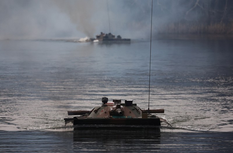 Polish Infantry fighting vehicle BWP crosses the lake during TUMAK-22 NATO exercises in an area known as the Suwalki Gap, of crucial significance to the security of the alliance's eastern flank, at a polygon in Klusy, Poland November 25, 2022. REUTERS/Kacper Pempel